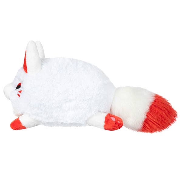 White mini kitsune plush lying down with red ears, red paws, and red-tipped tail.
