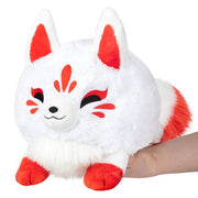 White mini kitsune plush with red ears, red tail tip, and stitched smiling face.