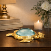 Brass turtle magnifying glass with domed blue-tinted lens and shell-shaped frame